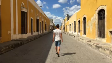 man walking on gray concrete road