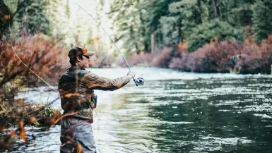 man fishing during daytime fishing rod
