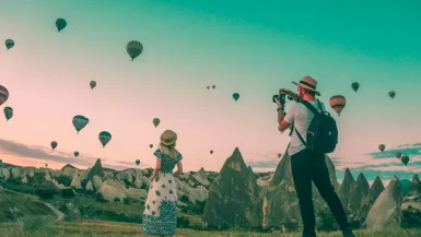 Best Places to Travel in April: Top Spring Getaways 45 man taking photo of hot air balloons and Best Places to Travel in April