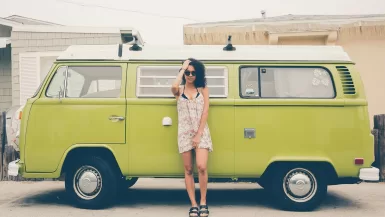 The Ultimate Guide to Choosing the Perfect Travel Dress 29 woman leaning on green bus in a Travel Dress