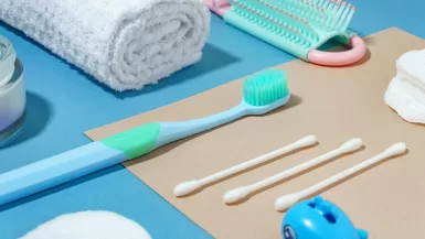 The Ultimate Buyer’s Guide to the Best Travel Toothbrushes 11 a blue toothbrush, toothpaste, toothpaste, and other items and Best Travel Toothbrushes
