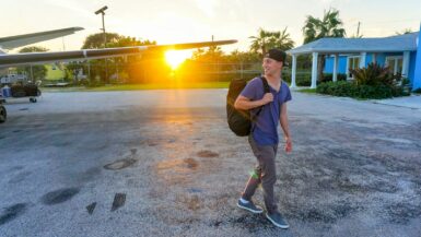 7 Travel Hacks to Save Time and Money on Your Next Trip 4 smiling man walking while looking side view Travel Hacks
