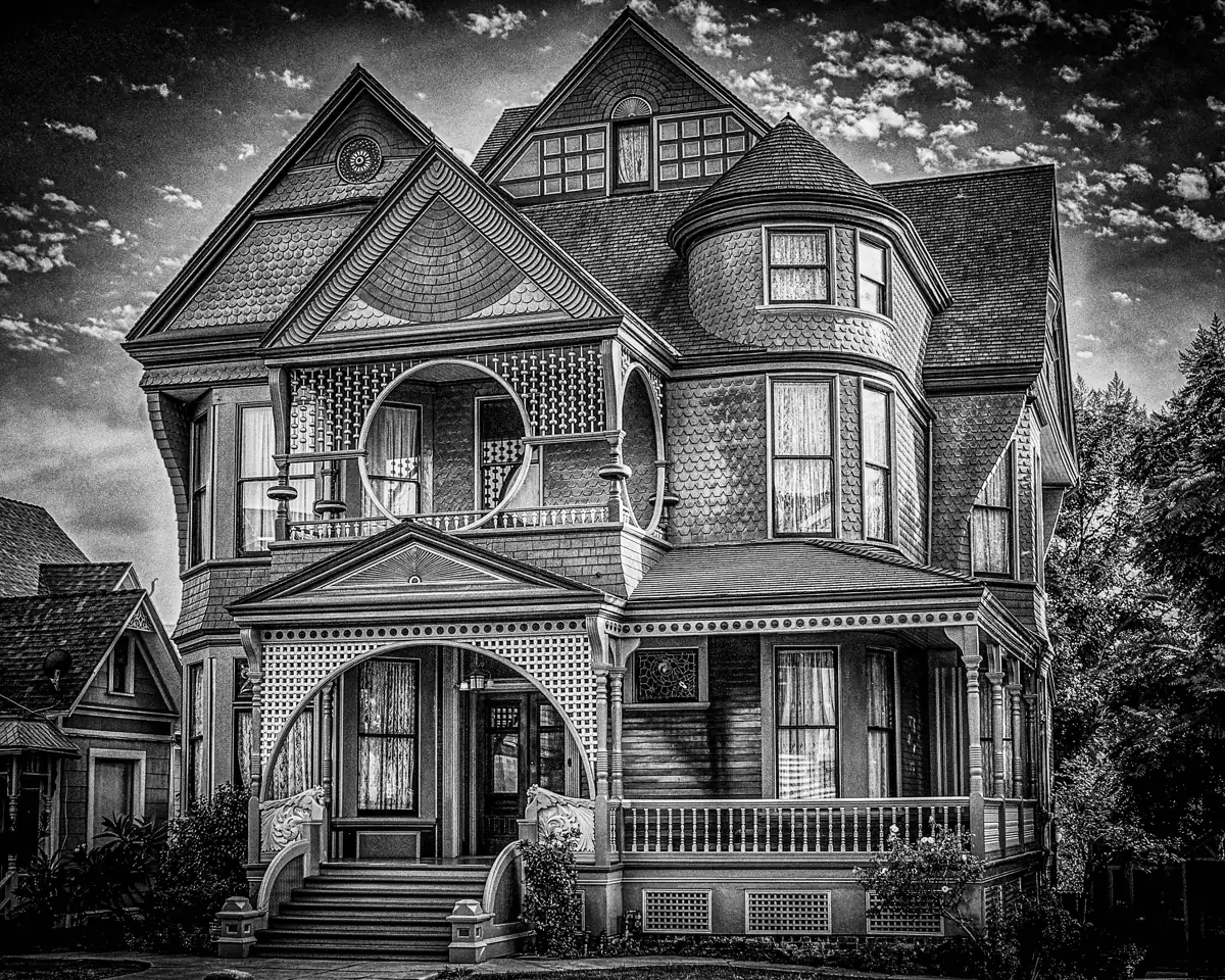 Black-and-white photo of a Victorian house with a corner tower on Carroll Avenue in Angelino Heights